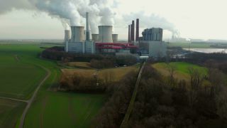 Link to Video | North Rhine-Westphalia, industrial building, smoke, energy supply, energy company, RWE Power, power station, environmental effects, Rhenish lignite mining area, environment, economic sector, Grevenbroich, building, aerial shot, particulates, sky, pollution, industrial sector, environmental protection