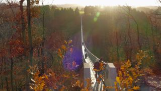 Link to Video | footbridge, landscape, Rhineland-Palatinate, tourist destination, bridge, suspension bridge, autumn, Hunsrück-Hochwald National Park, Germany, Geierlay, color, 4K resolution, landform, Hunsrück, footpath, simple suspension bridge, valley, forest, daytime, Kastellaun, tourist attraction, Sosberg, Mörsdorf, nature, architectural structure, thoroughfare, Rhein-Hunsrück-Kreis, point of interest