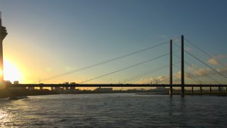 Link to Video | cargo ship, North Rhine-Westphalia, waterway, transport, cargo shipping, sunset, Düsseldorf, logistics, Germany, Rheinknie Bridge, river, Rhine, Rheinturm, thoroughfare