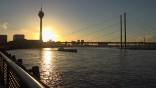 Link to Video | cargo ship, North Rhine-Westphalia, waterway, transport, cargo shipping, sunset, Düsseldorf, logistics, Germany, Rheinknie Bridge, river, Rhine, Rheinturm, thoroughfare