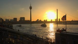 Link to Video | cargo ship, North Rhine-Westphalia, waterway, transport, cargo shipping, sunset, Düsseldorf, logistics, Germany, Rheinknie Bridge, river, Rhine, Rheinturm, thoroughfare