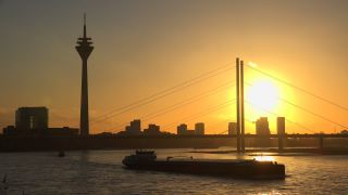 Link to Video | cargo ship, North Rhine-Westphalia, waterway, transport, cargo shipping, sunset, Düsseldorf, logistics, Germany, Rheinknie Bridge, river, Rhine, Rheinturm, thoroughfare