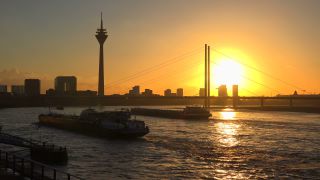 Link to Video | cargo ship, North Rhine-Westphalia, waterway, transport, cargo shipping, sunset, Düsseldorf, logistics, Germany, Rheinknie Bridge, river, Rhine, Rheinturm, thoroughfare