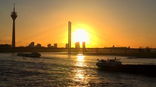 Link to Video | cargo ship, North Rhine-Westphalia, waterway, transport, cargo shipping, sunset, Düsseldorf, logistics, Germany, Rheinknie Bridge, river, Rhine, Rheinturm, thoroughfare