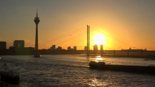 Link to Video | cargo ship, North Rhine-Westphalia, waterway, transport, cargo shipping, sunset, Düsseldorf, logistics, Germany, Rheinknie Bridge, river, Rhine, Rheinturm, thoroughfare