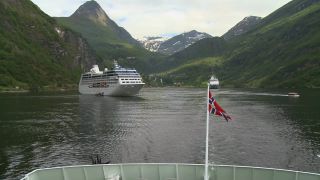 Link to Video | Geiranger, landscape, tourist destination, West Norwegian Fjords – Geirangerfjord and Nærøyfjord, body of water, cruise, Geirangerfjord, Norway, Scandinavia, natural heritage, cruise ship, fjord, Nordic countries, tourist attraction, transport, UNESCO World Heritage Site