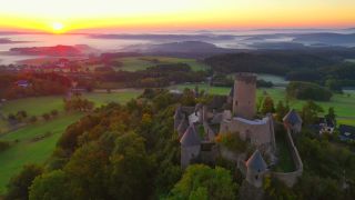 Link to Video | landscape, bird's-eye view, tourist destination, time of the day, landscape element, castle ruin, Nürburg Castle, terrain, sunrise, landform, Eifel (Rhineland-Palatinate), Europe, aerial shot, Adenau, tourist attraction, Nürburg, human-made geographic feature, architectural structure, Ahrweiler, point of interest