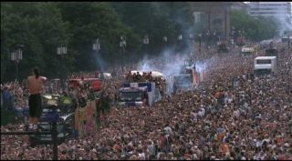 Link to Photo | occurrence, crowd, Love Parade, techno, Germany, screenshot, 1997, 1999, color, 35 mm film, July 12, Straße des 17. Juni, wide shot, Technoparade, 2K resolution, analog camera, capital city, queer, 35 Millimeter, photographic film, Berlin, Party (role-playing games), Berlin Babylon, documentary film