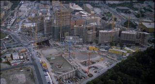 Link to Photo | office building, Potsdamer Platz, high-rise building, Germany, screenshot, 1998, color, 35 mm film, construction crane, high-angle shot, construction site, 2K resolution, aerial shot, capital city, daytime, photographic film, Berlin, Sony Center, Berlin Babylon
