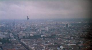 Link to Photo | establishing shot, Fernsehturm Berlin, big city, Mitte, Germany, metropolis, Mitte, screenshot, 1998, color, 35 mm film, wide shot, panorama, cityscape, 2K resolution, aerial shot, capital city, photographic film, Berlin, Berlin Babylon, cloud cover