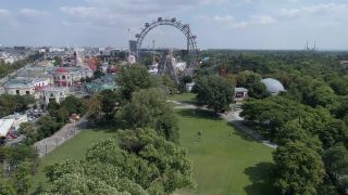 Link to Video | footage, big city, million city, Vienna, Federal State of Austria, amusement park, metropolis, Kaiserwiese, 4K resolution, 2019, federal capital, traveling carnival, Innere Stadt, Western Europe, Leopoldstadt, Wurstelprater, Austria, Europe, aerial shot, capital city, Ferris Wheel in Vienna
