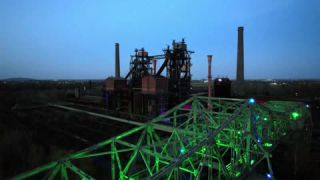 Link to Video | steel, JMW, North Rhine-Westphalia, tourist destination, bridge, artificial light, Ruhr, industrial heritage site, chimney, blast furnace, light installation, Germany, amusement park, Duisburg, color, urban park, landmark, 4K resolution, green, Meiderich, aerial shot, landmark, 2023, evening