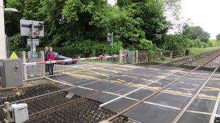 Link to Video | footage, United Kingdom, track, waiting, level crossing, Full High Definition, England, color, Great Britain, 2016, road, rail transport, daytime, boom barrier