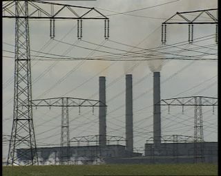 Link to Video | high voltage, electricity, fossil fuel, smoke, air pollution, Lübbenau/Spreewald, German Democratic Republic, chimney, power cable, 1990, color, standard-definition television, 1990s, greenhouse effect, sky, coal-fired power station, Betacam SP, transmission tower, eastern Germany