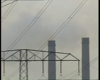 Link to Video | high voltage, electricity, fossil fuel, smoke, air pollution, Lübbenau/Spreewald, German Democratic Republic, chimney, power cable, 1990, color, standard-definition television, 1990s, greenhouse effect, sky, coal-fired power station, Betacam SP, transmission tower, eastern Germany