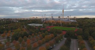 Link to Video | October, autumn, Olympic Stadium of Munich, big city, Munich, 2020, wide shot, Olympiapark, horizon, aerial shot, sky, tourist attraction, evening, cloud cover, Bavaria