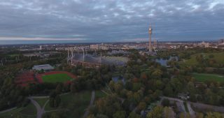 Link to Video | October, autumn, Olympic Stadium of Munich, big city, Munich, 2020, wide shot, Olympiapark, horizon, aerial shot, sky, tourist attraction, evening, cloud cover, Bavaria