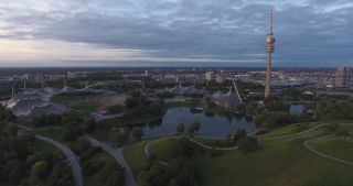 Link to Video | October, autumn, Olympic Stadium of Munich, big city, Munich, 2020, wide shot, Olympiapark, horizon, aerial shot, sky, tourist attraction, evening, cloud cover, Bavaria
