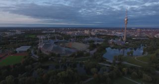 Link to Video | October, autumn, Olympic Stadium of Munich, big city, Munich, 2020, wide shot, Olympiapark, horizon, aerial shot, sky, tourist attraction, evening, cloud cover, Bavaria