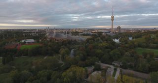 Link to Video | October, autumn, Olympic Stadium of Munich, big city, Munich, 2020, wide shot, Olympiapark, horizon, aerial shot, sky, tourist attraction, evening, cloud cover, Bavaria