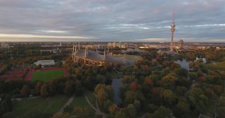 Link to Video | October, autumn, Olympic Stadium of Munich, big city, Munich, 2020, wide shot, Olympiapark, horizon, aerial shot, sky, tourist attraction, evening, cloud cover, Bavaria