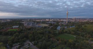 Link to Video | October, autumn, Olympic Stadium of Munich, big city, Munich, 2020, wide shot, Olympiapark, horizon, aerial shot, sky, tourist attraction, evening, cloud cover, Bavaria