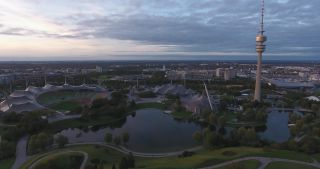 Link to Video | October, autumn, Olympic Stadium of Munich, big city, Munich, 2020, wide shot, Olympiapark, horizon, aerial shot, sky, tourist attraction, evening, cloud cover, Bavaria