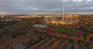 Link to Video | October, autumn, Olympic Stadium of Munich, big city, Munich, 2020, wide shot, Olympiapark, horizon, aerial shot, sky, tourist attraction, evening, cloud cover, Bavaria