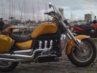 Link to Photo | cruiser, photograph, France, 2009, amateur photography, color, Vieux-Port de La Rochelle, Charente-Maritime, motorcycle, golden yellow, port, hobby, city, La Rochelle, Triumph Rocket 3, Triumph Rocket III, luxury good